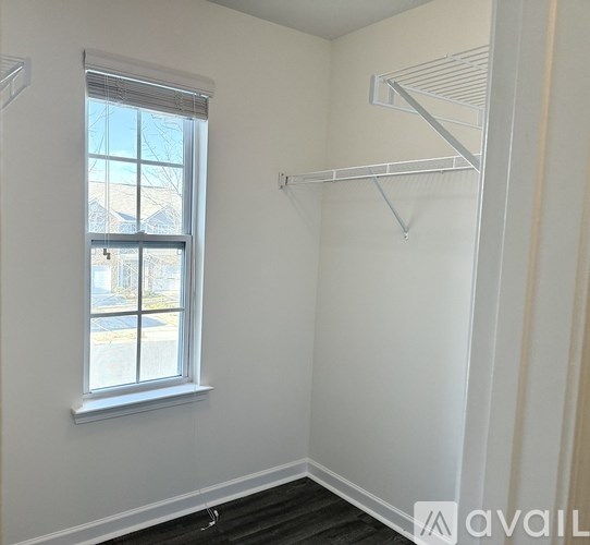A room with a window and a shelf is available.