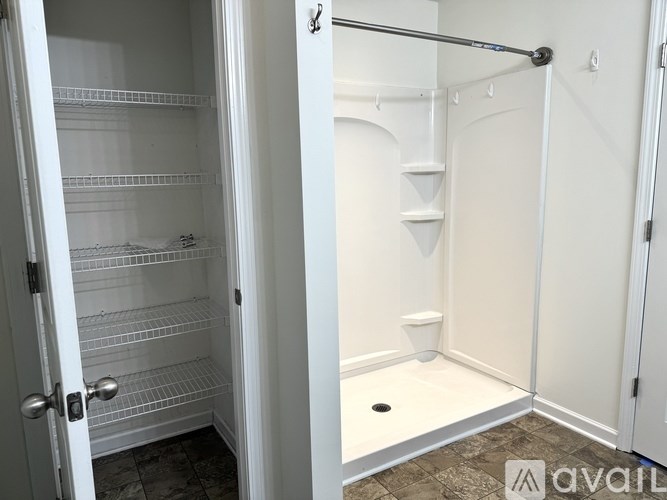 A white walk-in closet with shelves and a toilet.