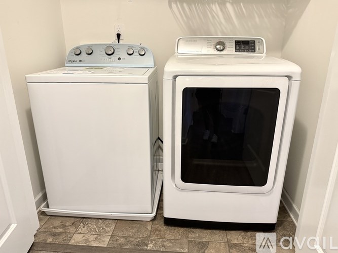 A white dishwasher and oven are in a small kitchen.