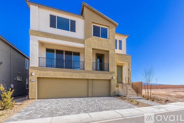 A modern two-story house with a garage is available for sale.