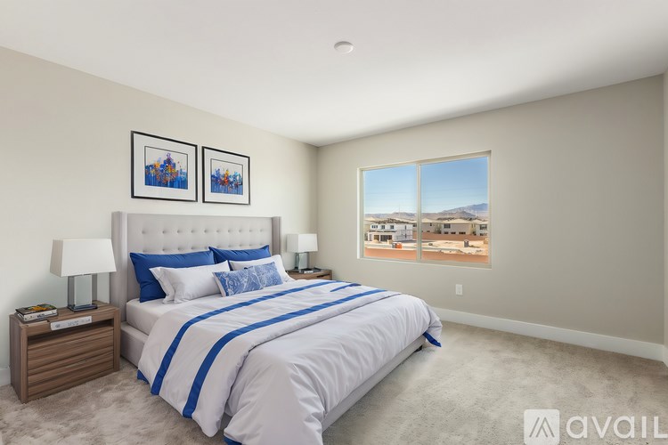A bedroom with a large bed and a view of the mountains through the window.
