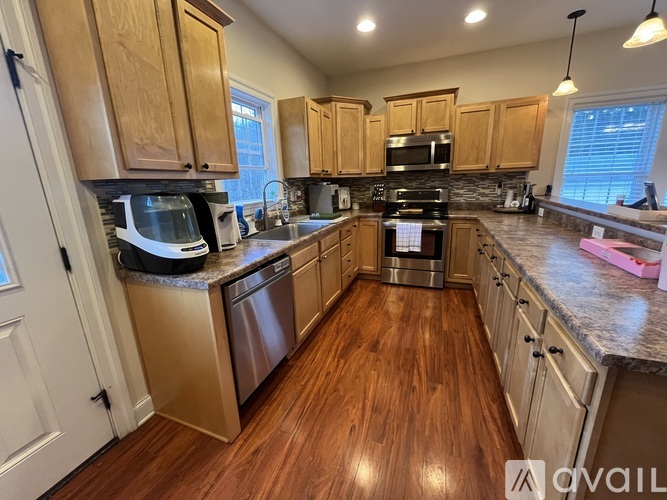A kitchen with wooden cabinets and stainless steel appliances.