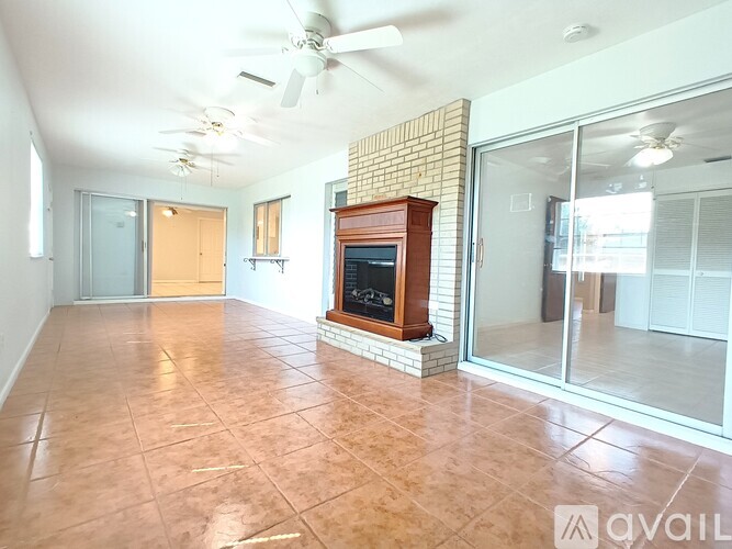 A living room with a fireplace and sliding glass doors.