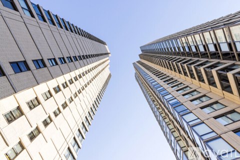 Two tall buildings with windows facing each other.