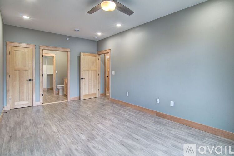 A room with wooden floors and a ceiling fan.