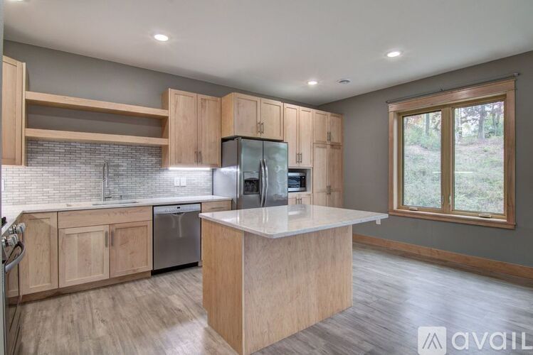A kitchen with wooden cabinets and a central island.