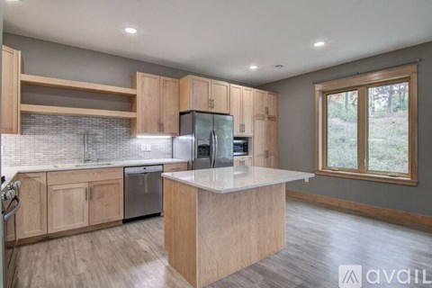 A kitchen with wooden cabinets and a central island.