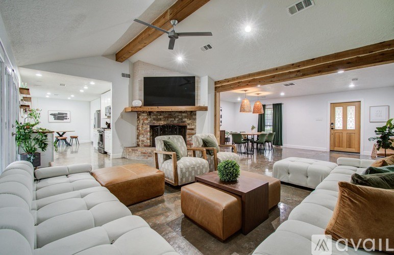 A living room with a fireplace and a television.