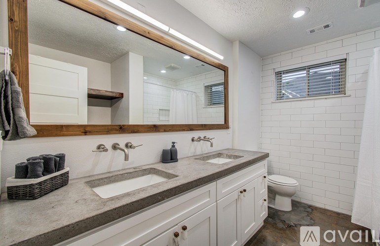 A bathroom with a white sink and toilet.