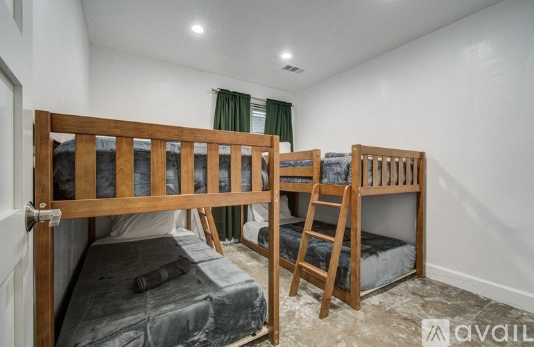 A room with two bunk beds and a ladder.