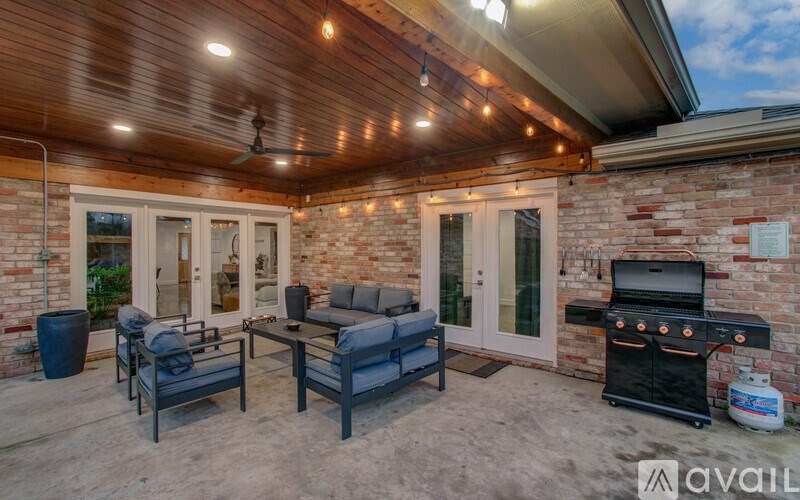 A patio with a grill and seating area.