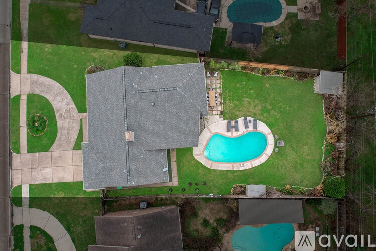 A bird's eye view of a house with a pool in the backyard.