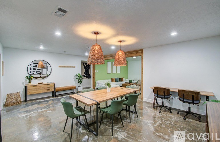A room with a dining table and chairs.