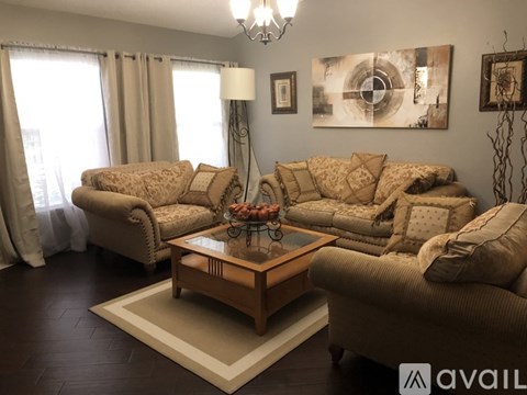 A living room with a large sectional sofa and a coffee table.