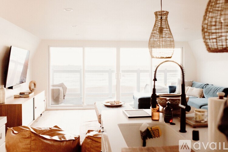 A living room with a couch, a table, and a window.