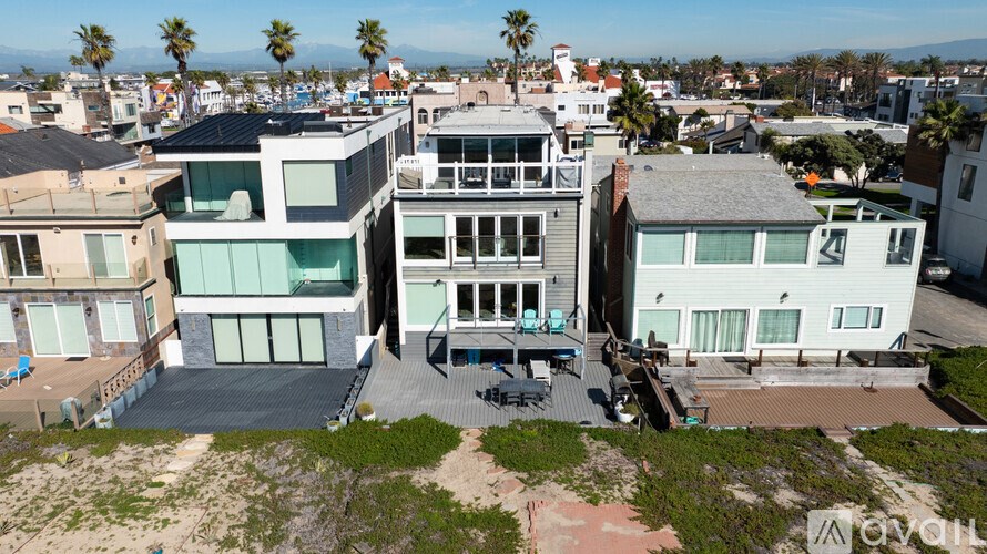A row of beach houses with a clear sky above them.