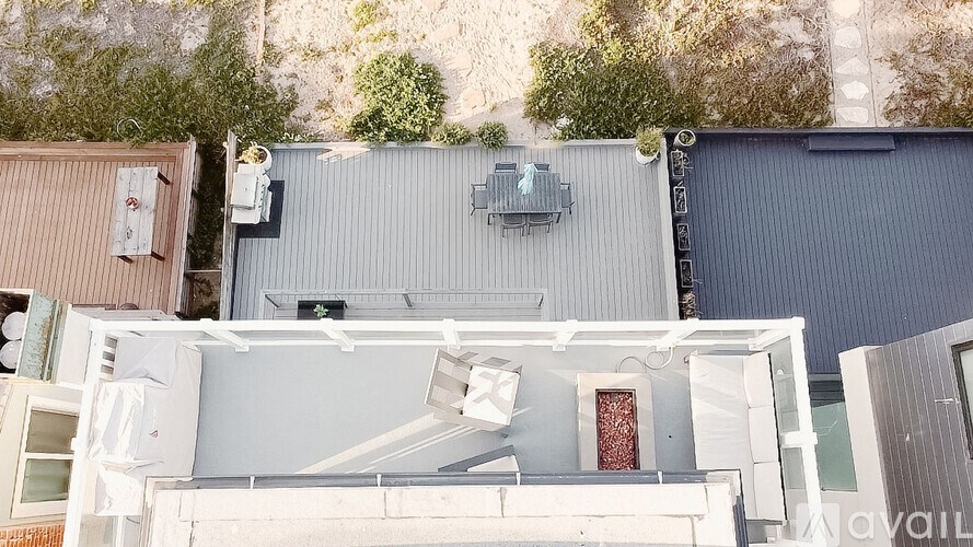 A modern house with a flat roof and a grey exterior.
