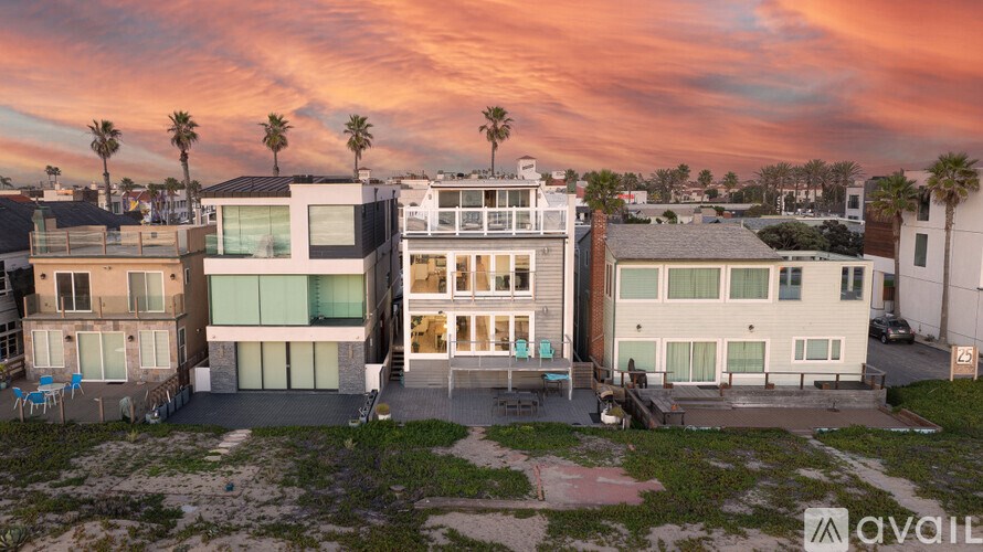 A row of modern houses with glass doors and balconies are shown in the image.