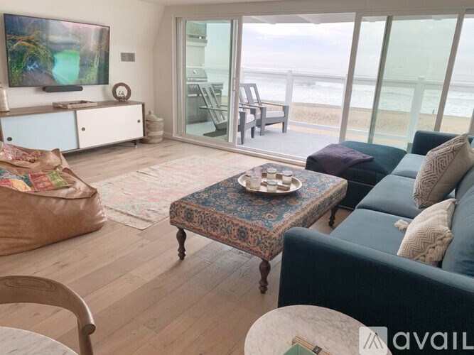 A living room with a couch, a table, and a television.