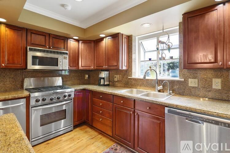A kitchen with wooden cabinets and stainless steel appliances.