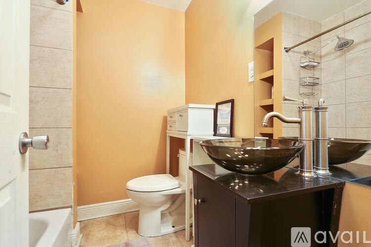 A bathroom with a toilet, sink, and shower.