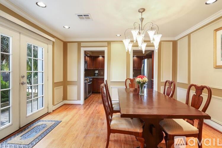 A dining room with a wooden table and chairs.