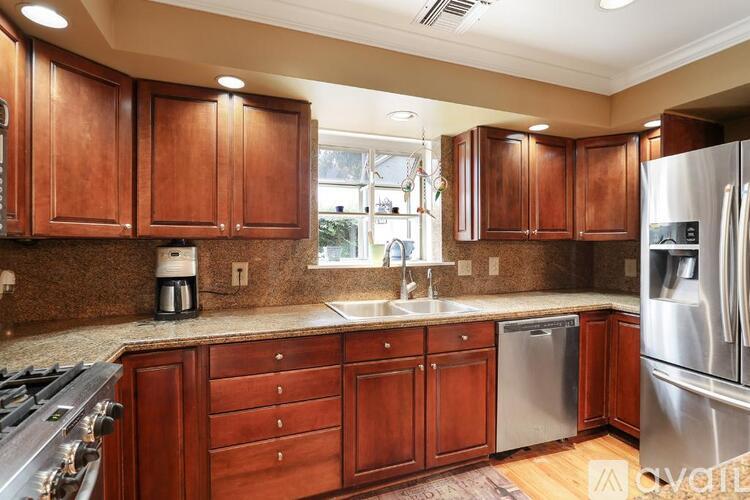 A kitchen with wooden cabinets and stainless steel appliances.