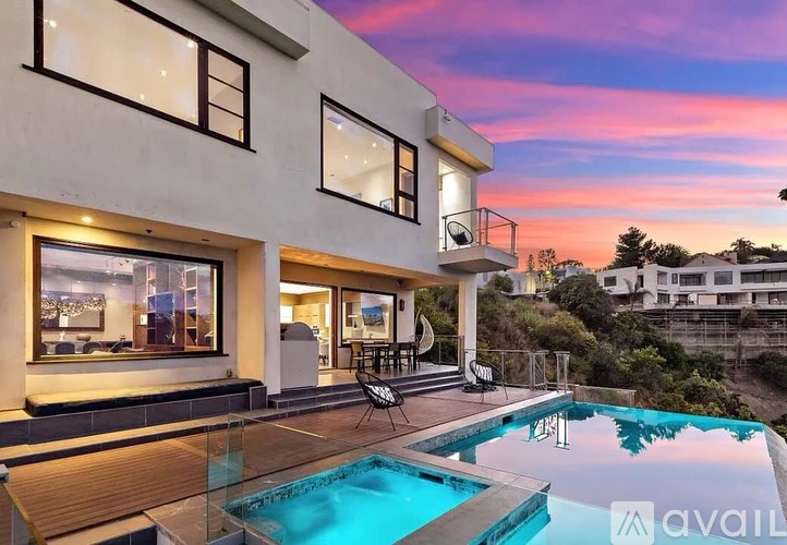 A modern house with a pool in the backyard.