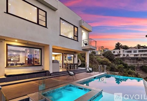 A modern house with a pool in the backyard.
