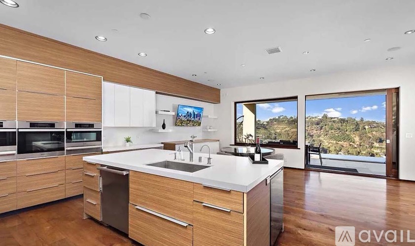 A modern kitchen with wooden cabinets and a large island.