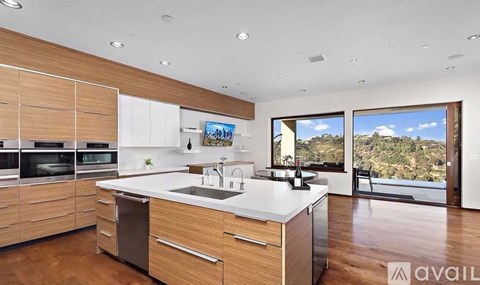 A modern kitchen with wooden cabinets and a large island.