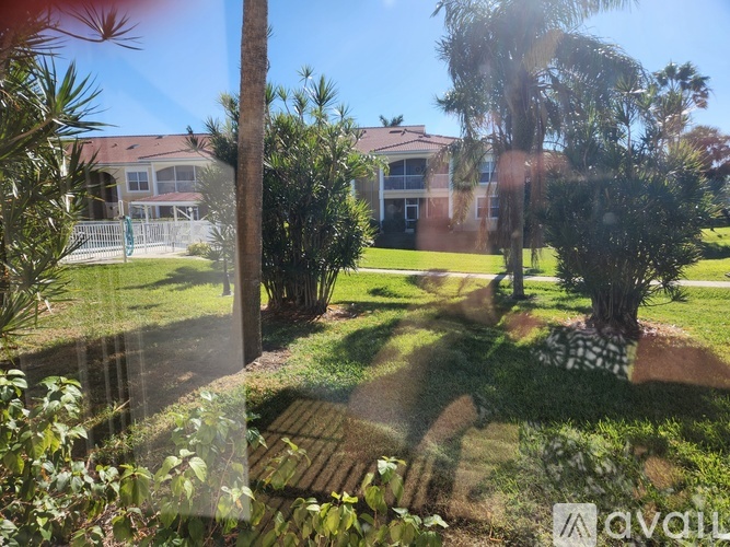 A house with a lawn and trees in front of it.