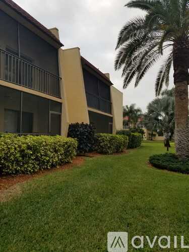 A building with a palm tree in front of it.