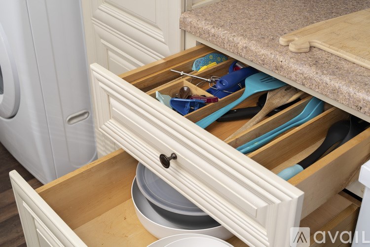 A drawer full of kitchen utensils and containers.