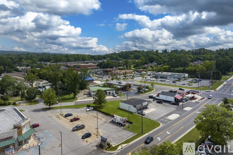 A view of a parking lot with cars and buildings in the background.