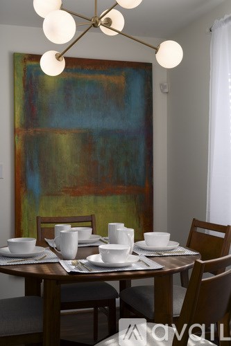 A dining table set with white cups and plates.