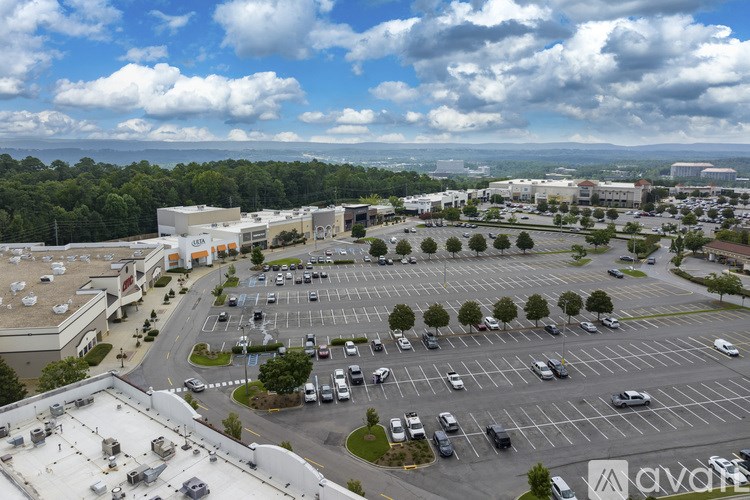 A parking lot with cars and a building in the background.