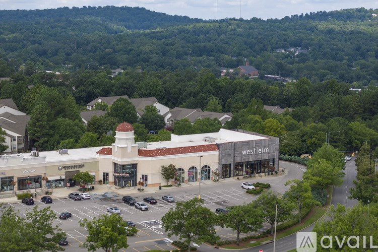 A large shopping center with a parking lot in front.