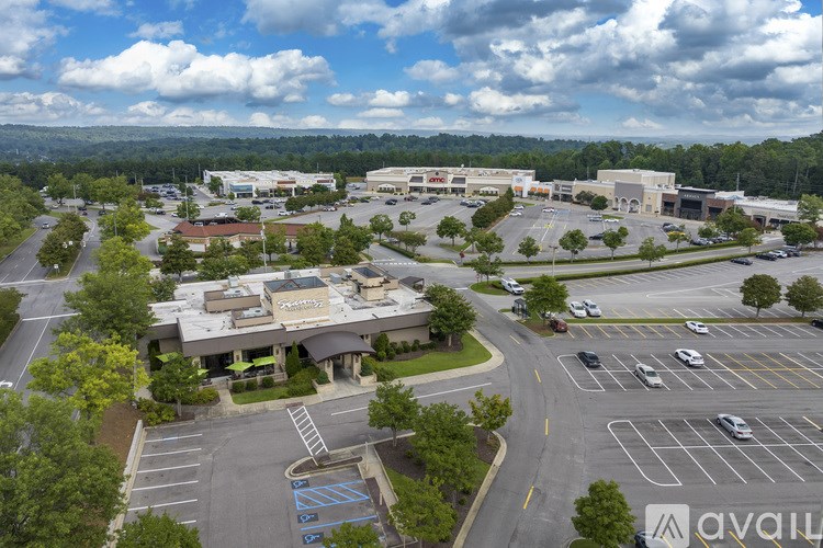 A large commercial building with a parking lot in front of it.