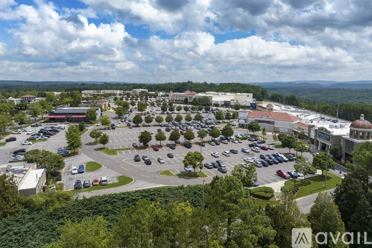 A parking lot with cars and a building in the background.