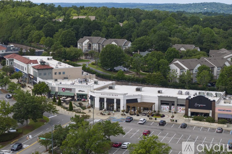 A view of a shopping area with a car dealership in the foreground.