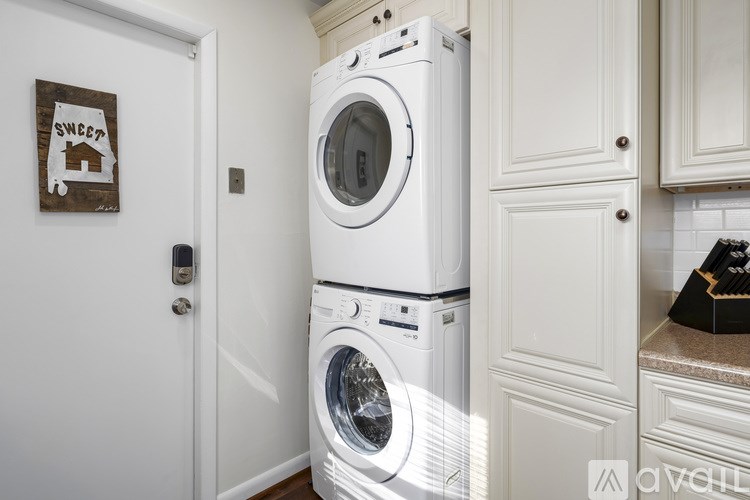 A white washing machine and dryer in a laundry room.