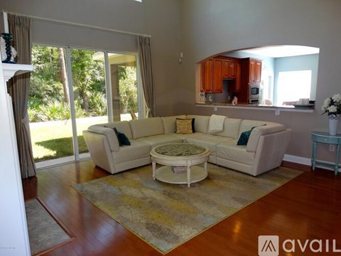 A living room with a white couch and a coffee table.