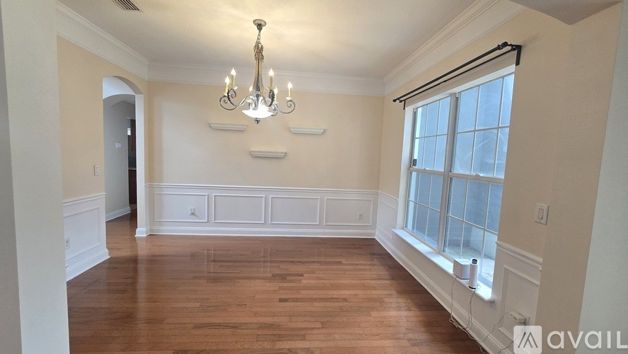 A living room with a television and a white couch.