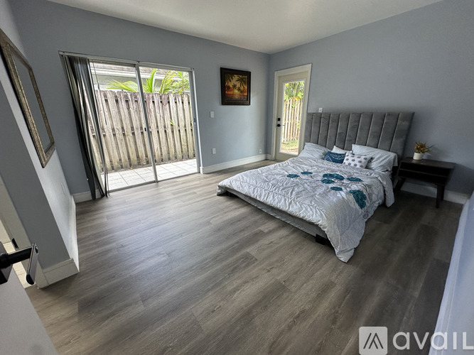 A bedroom with a large bed and a painting on the wall.