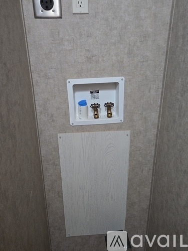 A wall socket with a switch and a plug in a white box.