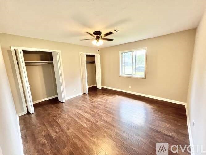 A room with a ceiling fan and a window.