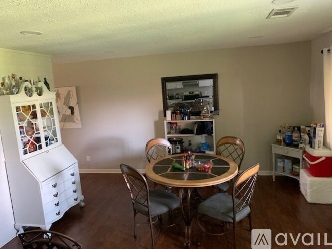 A dining room with a round table and chairs.