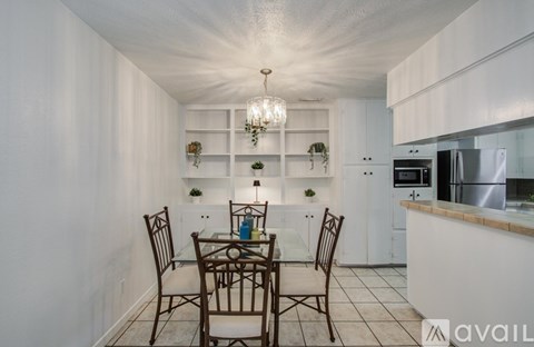 A dining room with a table set for two.