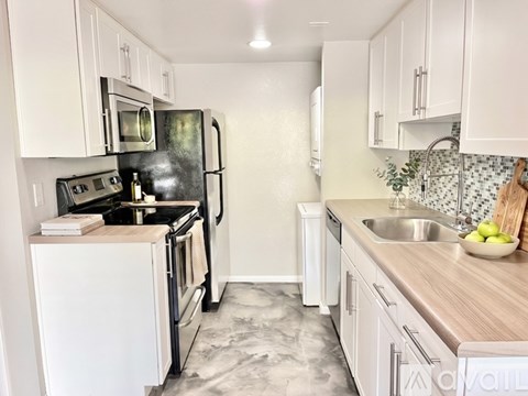 A kitchen with a sign offering a free first month for moving in.